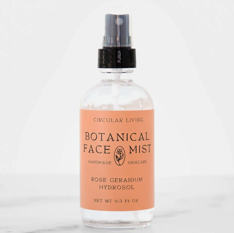 Bottle of Botanical Face Mist with a peach-colored label on a white background