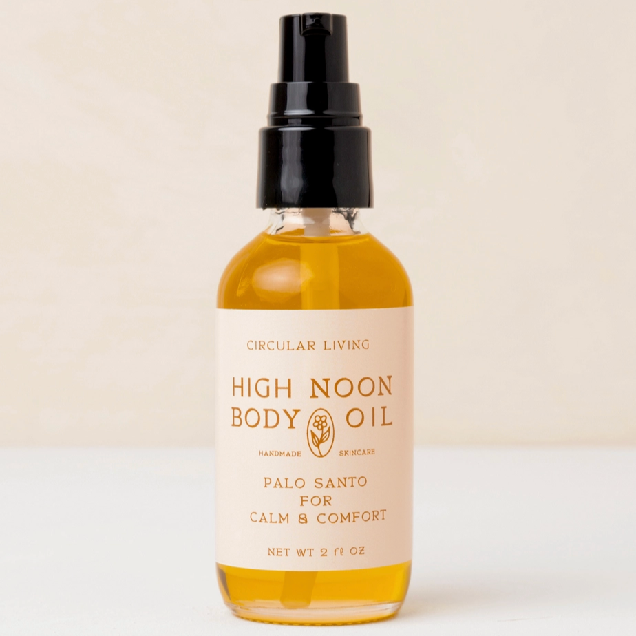 Bottle of High Noon Body Oil with a beige label on a white background