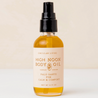 Bottle of High Noon Body Oil with a beige label on a white background