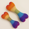 Two rainbow-colored heart-shaped dog toys on a light background